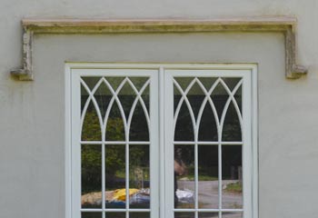 Recessed Cothic casement windows of unusal proportion