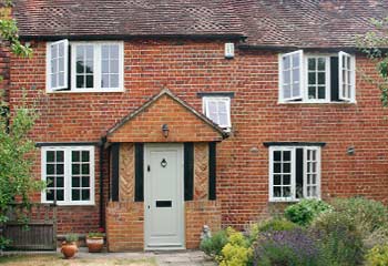 Opening the view. The original timber windows had bulky top openers and transoms which were redesigned to take advantage of uninterrupted countryside views and softened the look for this cosy and rustic period cottage.
